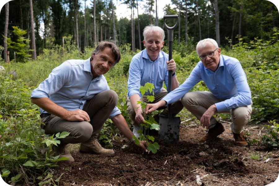 3 men planting a tree representing Dr Schutz green initiatives